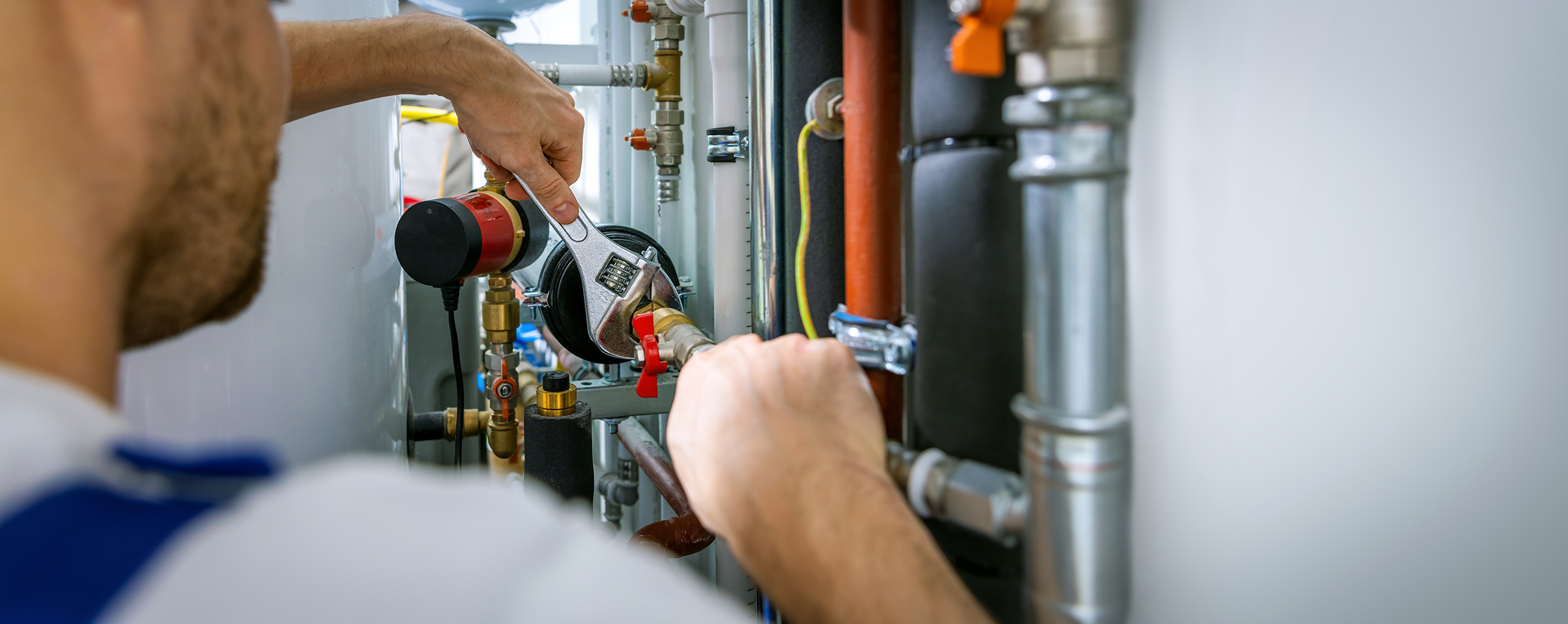 Plumber tightening a fitting on a copper supply line